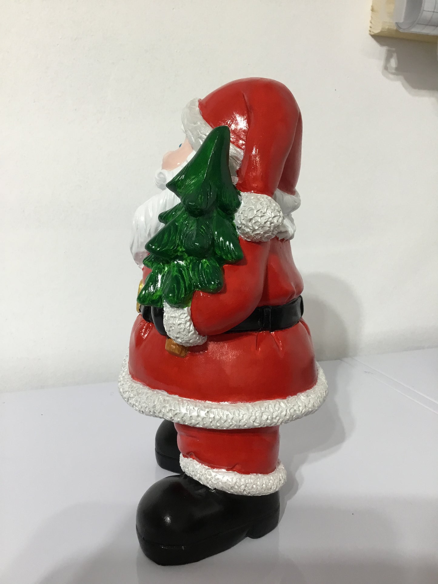 Santa Claus Holding Present and Tree